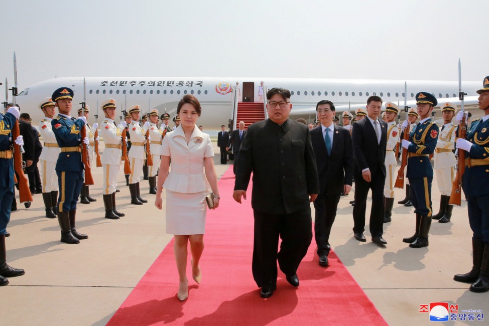 North Korean leader Kim Jong Un and his wife Ri Sol Ju walk upon arriving in Beijing, China