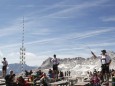 Goasslschnoizer take part in a whip cracking interlude on Germany's tallest mountain Zugspitze