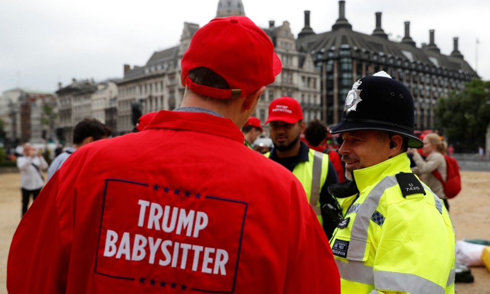 Police officers talk to demonstrators preparing to protest in Parliament Square, during the visit by U.S. President Donald Trump and First Lady Melania Trump in London