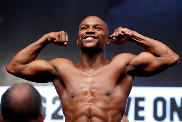 FILE PHOTO: Boxer Floyd Mayweather Jr. of the U.S. poses in the scale during his official weigh-in at T-Mobile Arena in Las Vegas