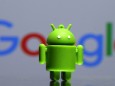 FILE PHOTO - A 3D printed Android mascot Bugdroid is seen in front of a Google logo in this illustration