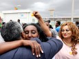 Relatives embrace after meeting at Asmara International Airport, after one of them arrived aboard the Ethiopian Airlines flight in Asmara