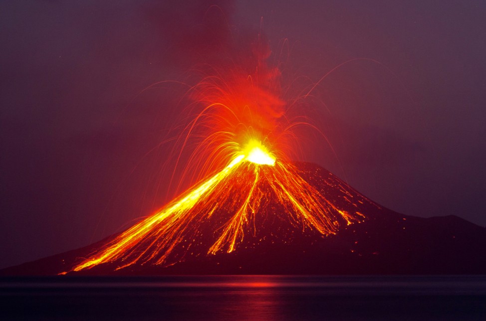 Lava streams down from Anak Krakatau (Child of Krakatoa) volcano during an eruption as seen from Rakata island