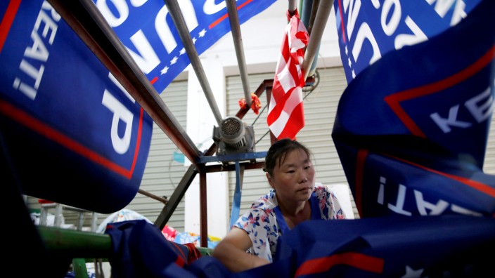 A worker makes flags for U.S. President Donald Trump's 'Keep America Great!' 2020 re-election campaign at Jiahao flag factory in Fuyang