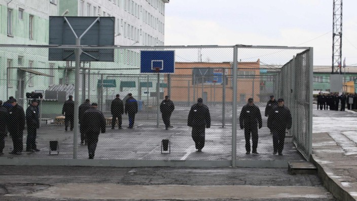 Inmates walk inside an enclosure at a high-security male prison camp outside Russia's Siberian city of Krasnoyarsk