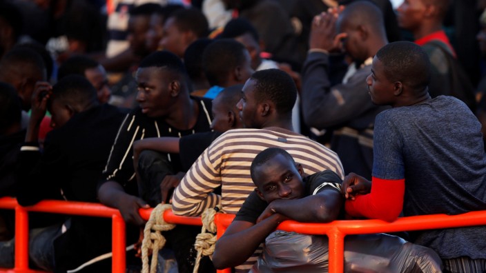 Migrants are seen on a rescue boat as they wait to disembark after arriving at the port of Malaga