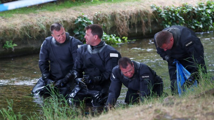 Police officers search a river in Queen Elizabeth Gardens in Salisbury