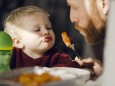 Father feeding his little son with tasty pasta model released Symbolfoto property released PUBLICATI