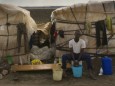 An African immigrant sits by his shack in a makeshift camp in the countryside near the village of Rignano Garganico
