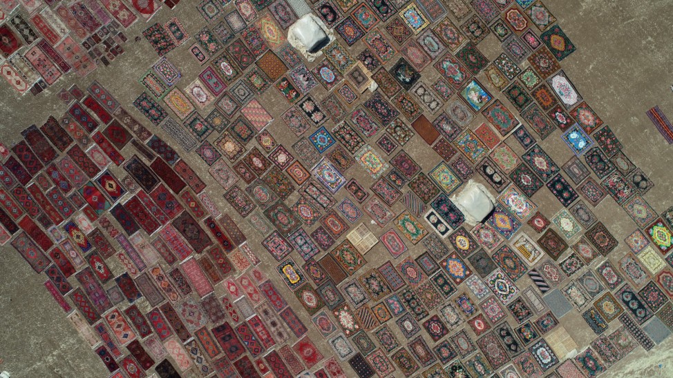 Carpets are laid out in fields to soften their colors under sizzling sun are seen in Dosemealti