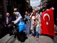 People stroll at Mahmutpasa street, a popular middle-class shopping district, in Istanbul