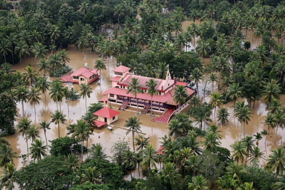 An aerial view shows partially submerged houses and church at a flooded area in the southern state of Kerala
