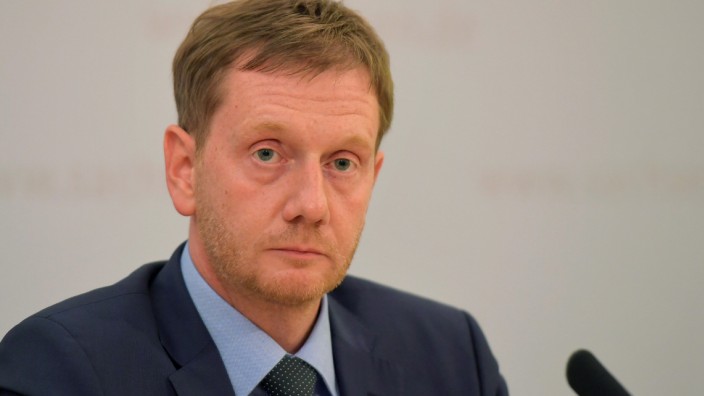 SaxonyâÄÖs state premier Michael Kretschmer addresses a news conference in Dresden