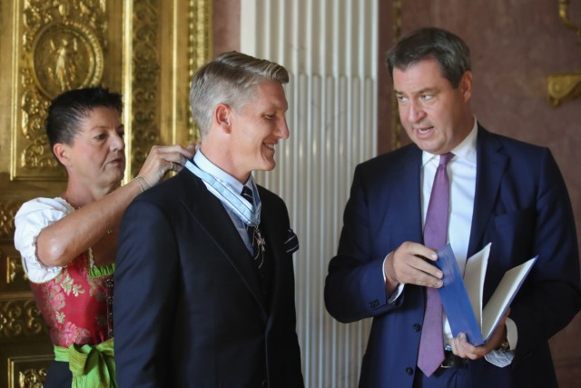 Prime Minister Dr. Markus Soeder Honors Bastian Schweinsteiger With The Bavarian Order Of Merit