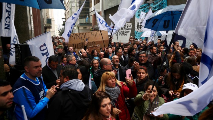 State workers gather during a protest against layoffs outside the Ministry of Justice in Buenos Aires' financial district
