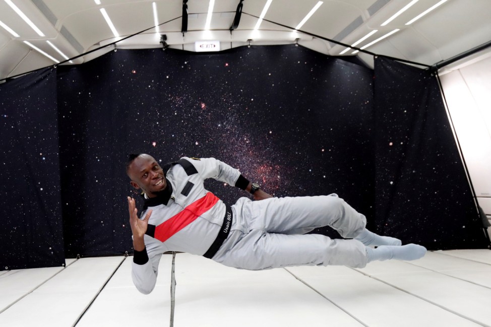 Retired sprinter Usain Bolt poses as he enjoys zero gravity conditions during a flight in a specially modified plane above Reims