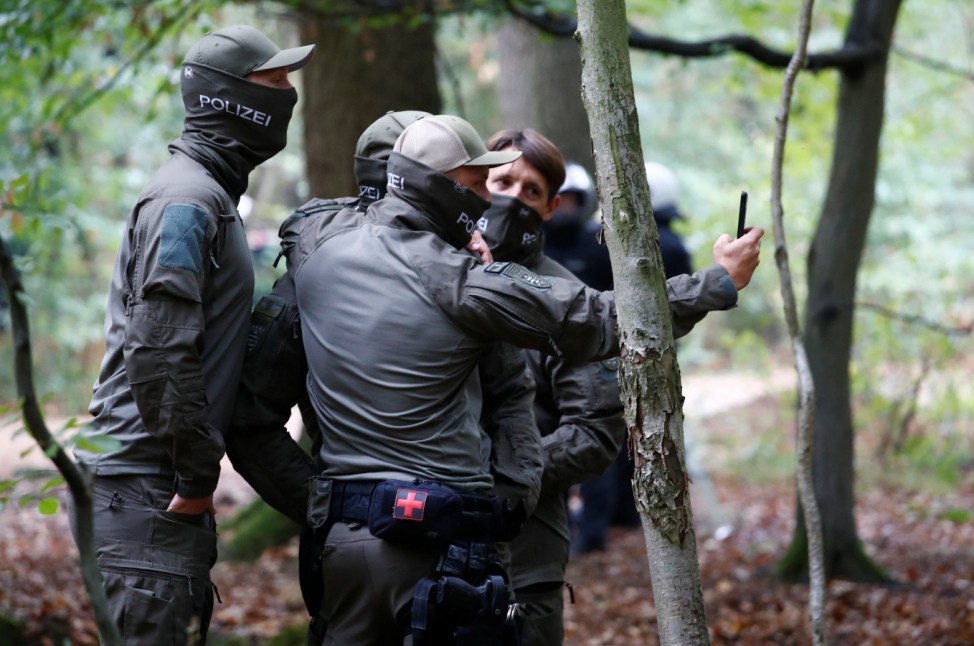 Police officers make a selfie as they prepare to clear the area at the 'Hambacher Forst' in Kerpen-Buir near Cologne