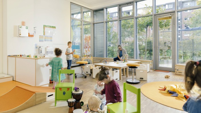 Pre school teacher and children in playing in learning room in kindergarten model released Symbolfo