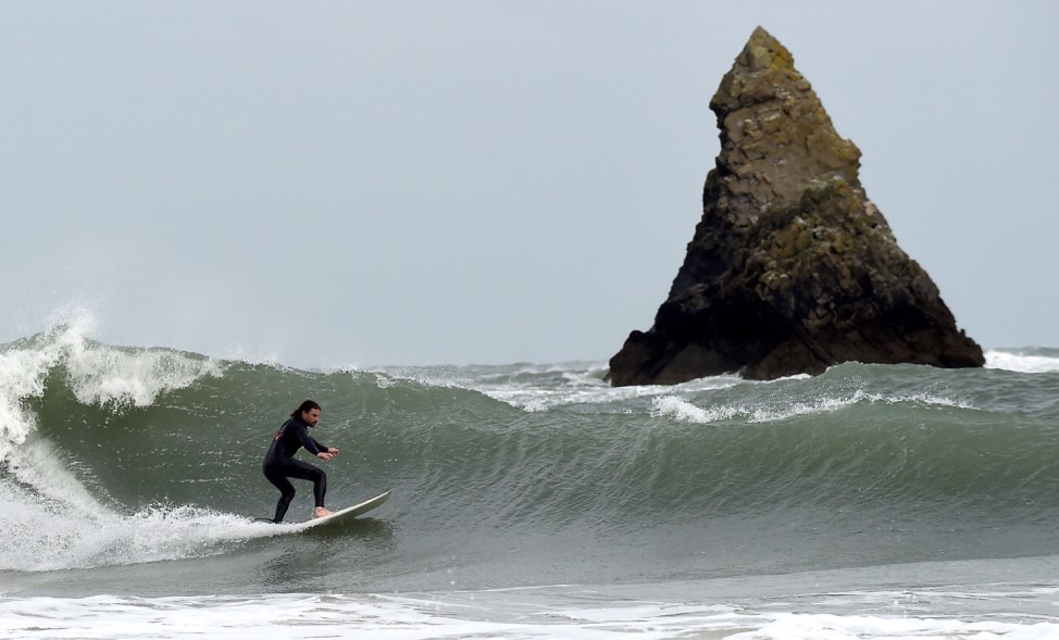 A surfer attempts to ride large waves near Broad Haven