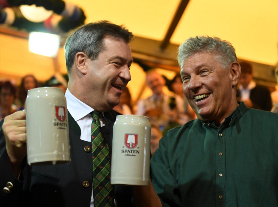 Munich mayor Dieter Reiter and Bavarian State Prime Minister Markus Soeder toast with beers at the opening day of the 185th Oktoberfest in Munich