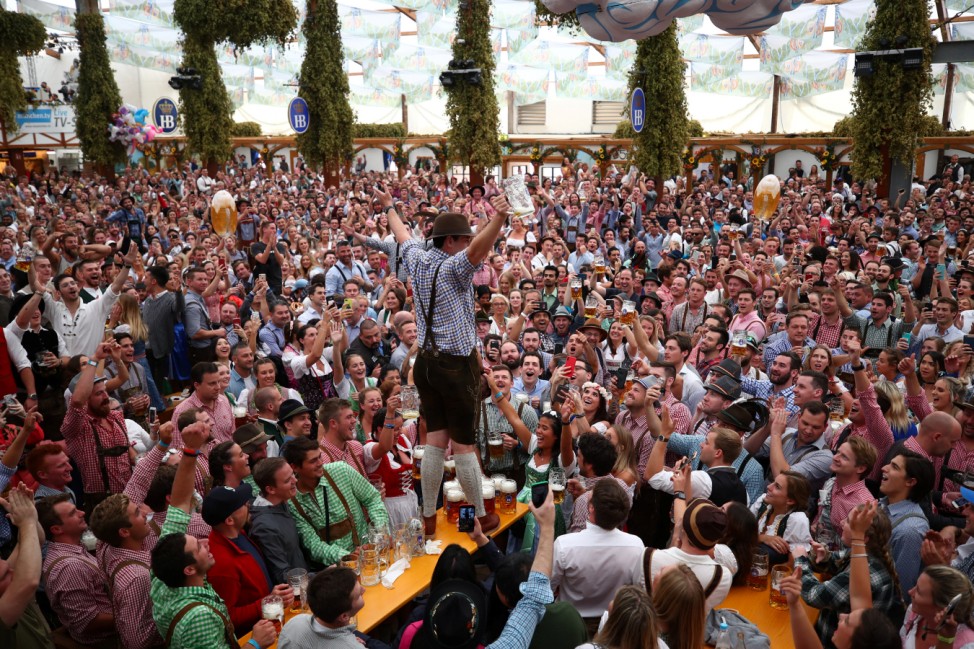 Visitors cheer during the opening day of the 185th Oktoberfest in Munich