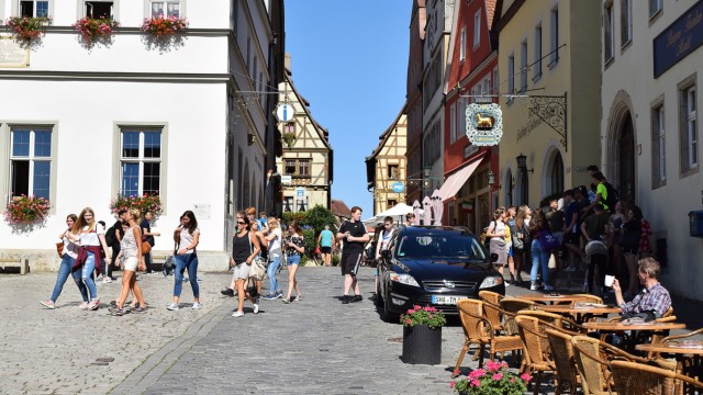 Rothenburg ob der Tauber: Teilen sich die Gasse neben dem Marktplatz: Fußgänger, Autofahrer und Cafébesucher.