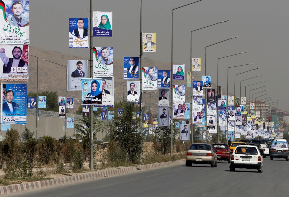 Election posters of parliamentarian candidates are installed during the first day of elections campaign in Kabul