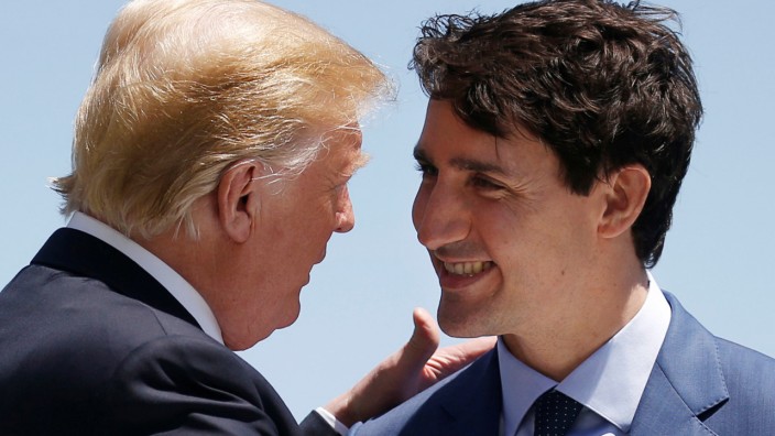 FILE PHOTO: U.S. President Donald Trump is greeted by Canada's Prime Minister Trudeau as he arrives at the G7 Summit in Charlevoix