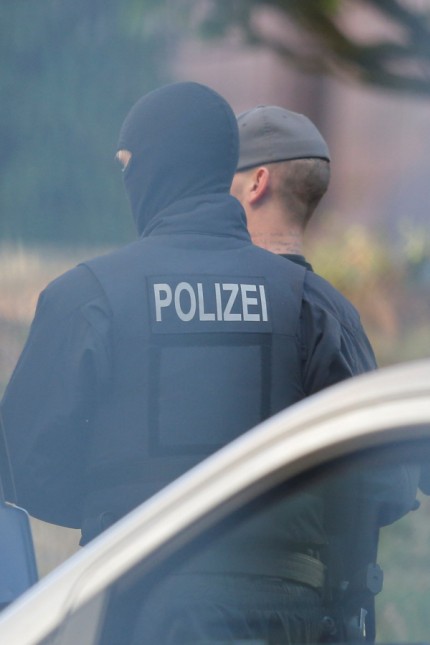 Men suspected of forming a far-right militant organisation in Chemnitz, are escorted by special police in front of the General Prosecutor's Office at the German Federal Supreme Court in Karlsruhe