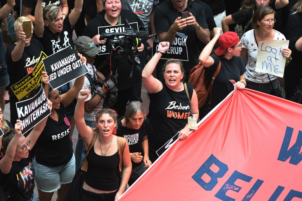 Activists rally in opposition to the confirmation of U.S. Supreme Court nominee Kavanaugh inside the Senate Hart Office Building in Washington