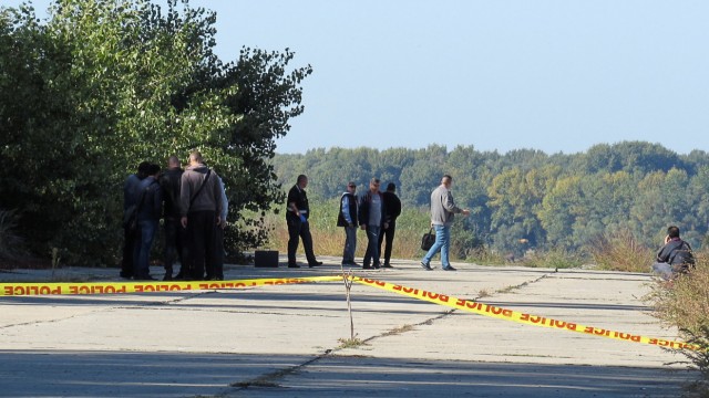 Police investigators walk near a crime scene where TV journalist Viktoria Marinova was murdered in Ruse