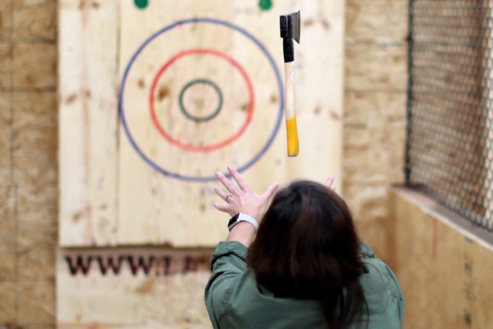 Teri Watson participates in axe throwing, a sport that started in the Canadian backwoods and is growing in popularity in U.S. cities, at LA Ax in North Hollywood, Los Angeles