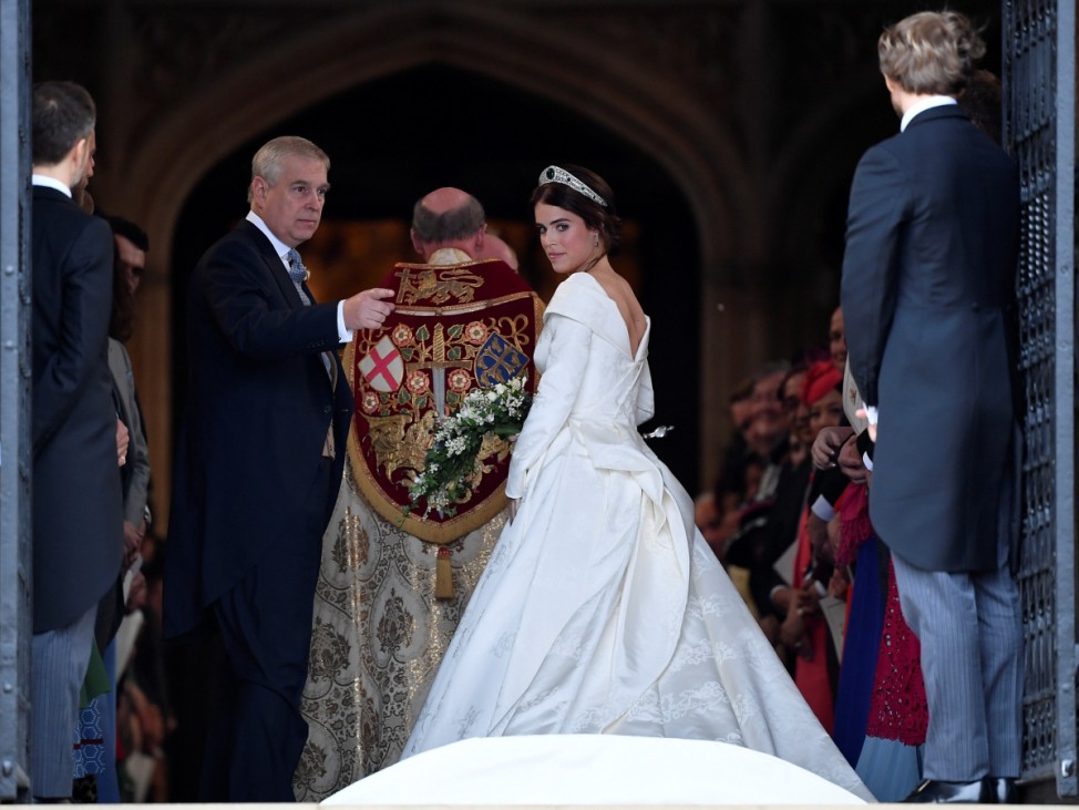Britain's Princess Eugenie enters St George's Chapel with her father Prince Andrew, Duke of York, for her wedding to Jack Brooksbank in Windsor Castle, Windsor