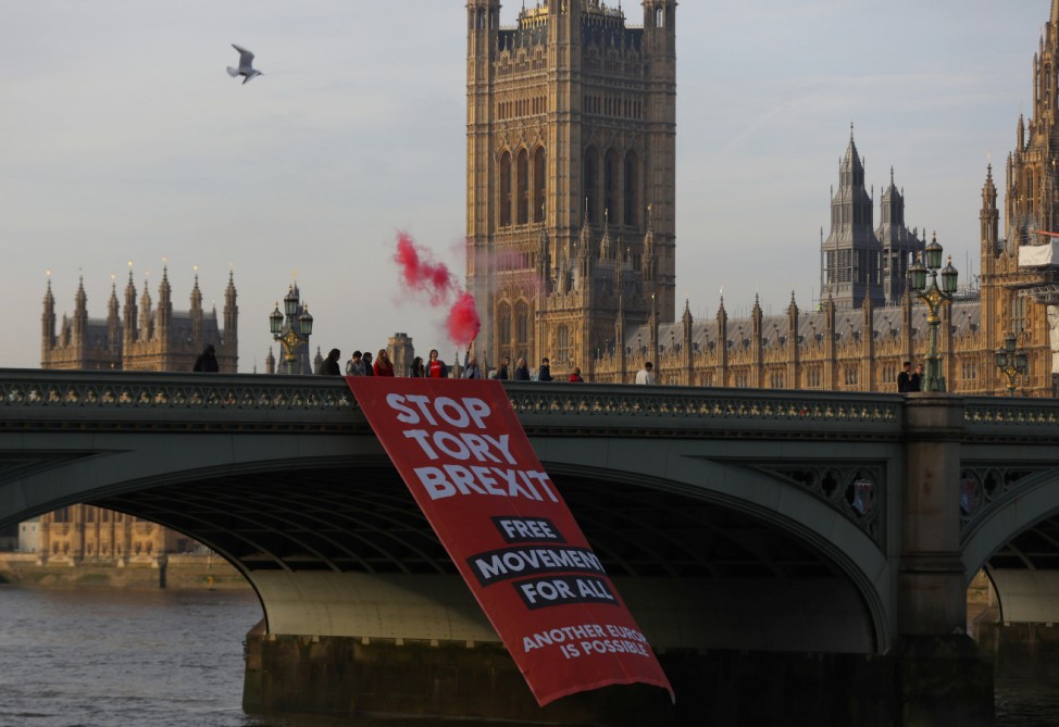 Protesters unfurl a banner on Westminster Bridge before an anti-Brexit demonstration, in central London