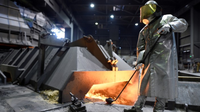 FILE PHOTO: A worker of German steel manufacturer Salzgitter AG stands in front of a furnace at a plant in Salzgitter