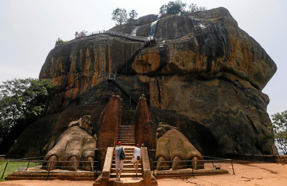 Tourists climb up to the UNESCO listed World Heritage Site Sigiriya Rock Fortress in Sigiriya