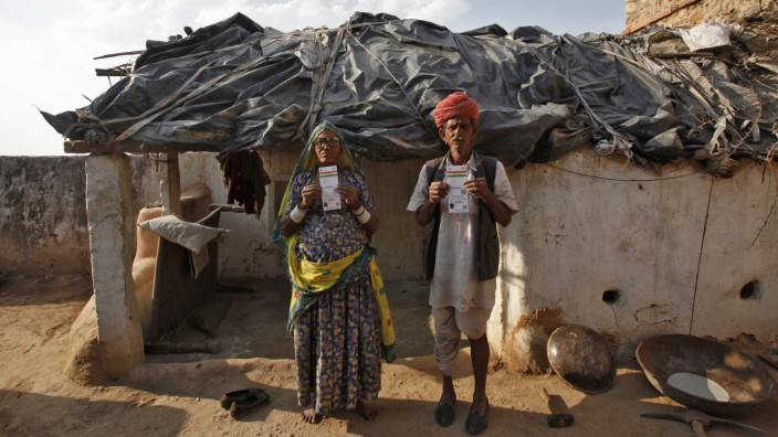 Ram and his wife Champa display their UID cards outside their hut at Merta district in Rajasthan