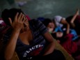 Maria Nino, migrant from Honduras and part of a caravan trying to reach the U.S., rests next to her relatives in a public square as they wait to regroup with more migrants, in Tecun Uman