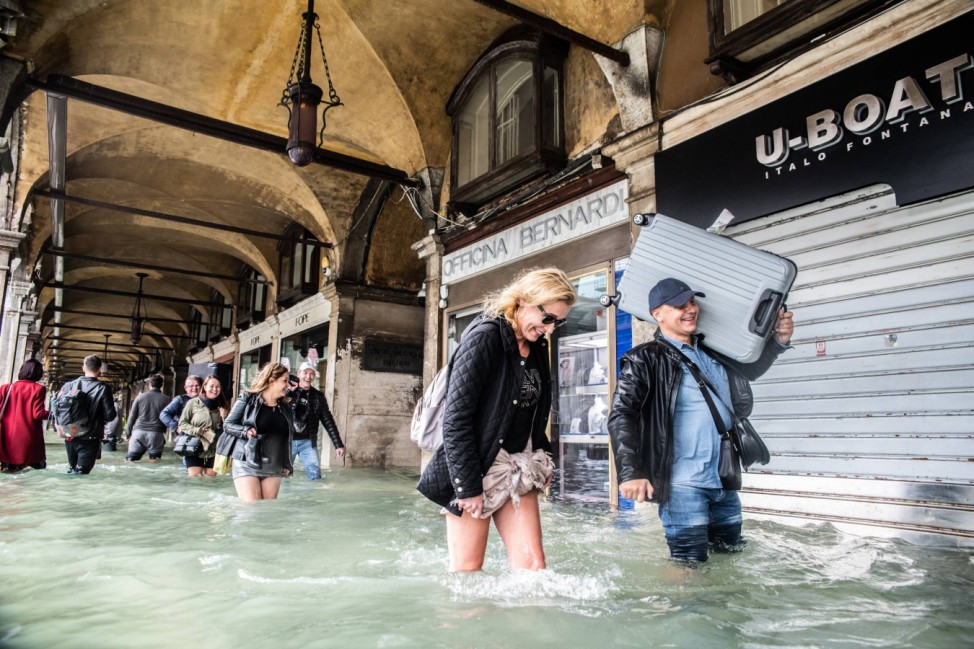 October 29 2018 Venice Italy People walk in a flooded street of Venice after according to ci