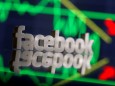FILE PHOTO: A 3D-printed Facebook logo is seen in front of displayed stock graph