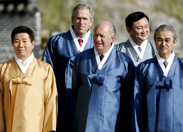 Leaders pose for picture wearing traditional Korean clothes in Pusan