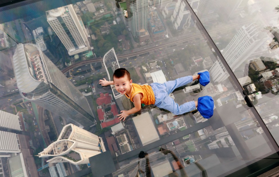 A boy plays on the glass at Thailand's first skywalk in Bangkok