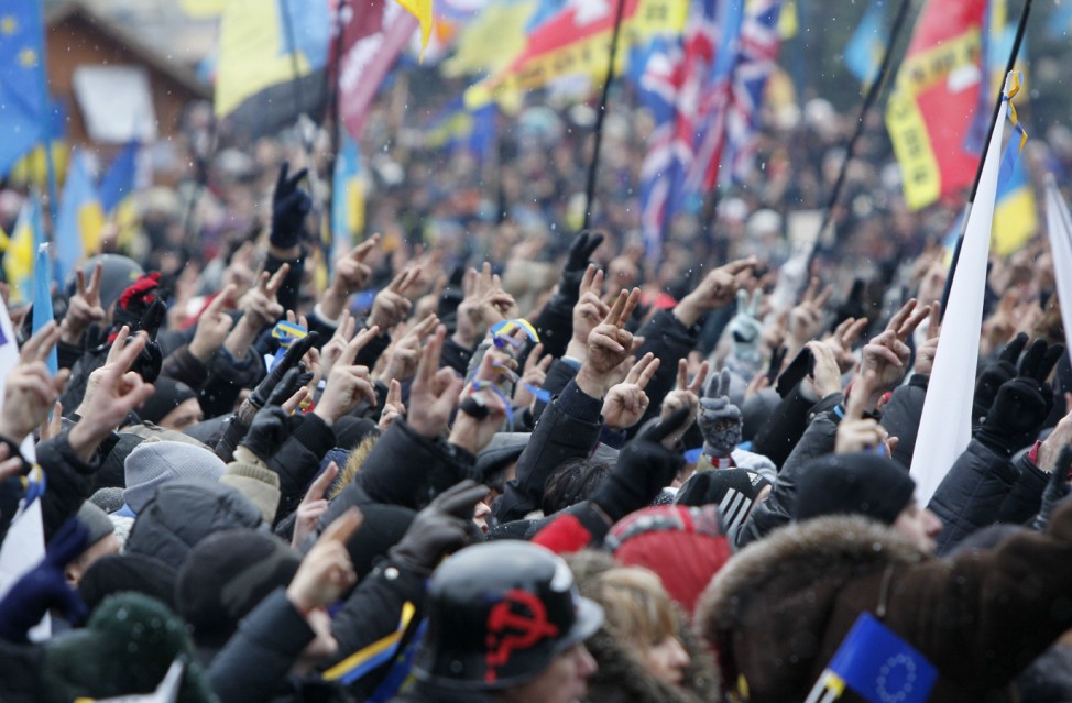 People gesture during a rally organized by supporters of EU integration at Maidan Nezalezhnosti or Independence Square in central Kiev