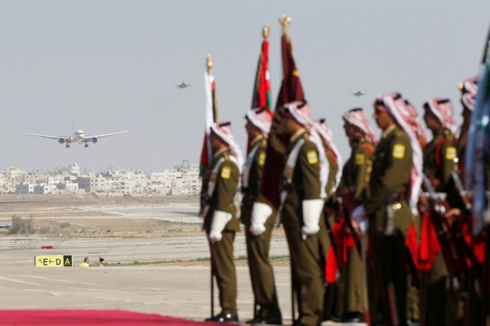 Abu Dhabi's Crown Prince Sheikh Mohammed bin Zayed al-Nahyan's plane is seen approaching for landing, as Jordanian honour guards stand at Amman military airport