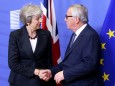 British Prime Minister Theresa May shakes hands with European Commission President Jean-Claude Juncker before a meeting to discuss draft agreements on Brexit, at the EC headquarters in Brussels