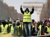 A protester wearing yellow vest, a symbol of a French drivers', protest against higher fuel prices, gestures during clashes on the Champs-Elysees in Paris