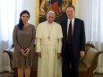 FILE PHOTO: Pope Francis poses with Vatican spokesman Greg Burk and deputy Vatican spokesperson Paloma Garcia Ovejero during a meeting at the Vatican
