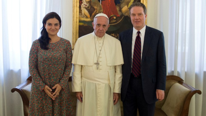 FILE PHOTO: Pope Francis poses with Vatican spokesman Greg Burk and deputy Vatican spokesperson Paloma Garcia Ovejero during a meeting at the Vatican