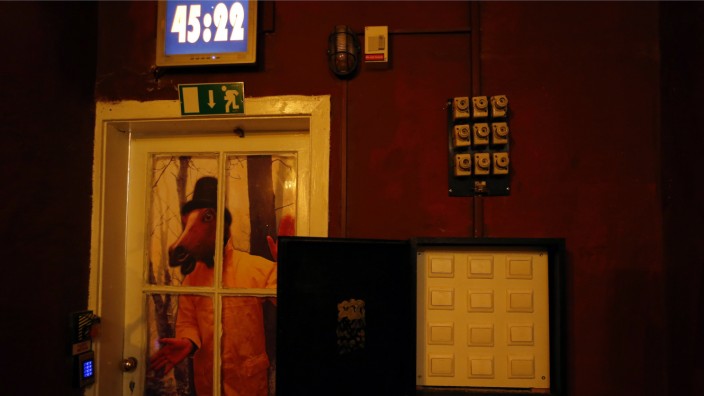 A clock, clues and locks are seen in an escape room at ExitPointGames in Budapest
