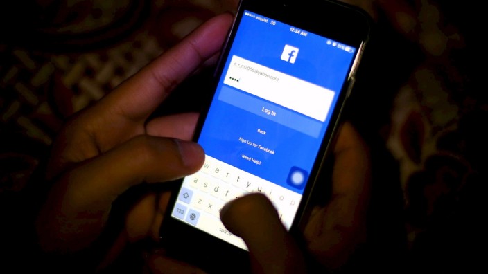 A man tries to login to the Facebook social media website in Cairo